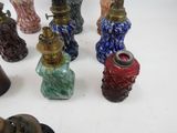 many different colored vases sitting on a white surface
