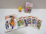 dragon ball trading cards and action figures are on a table
