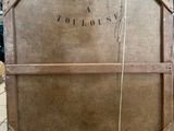 an old wooden crate sitting on the floor with a sign on it