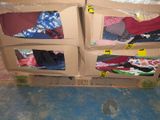 three boxes of clothes sitting on the floor in a room