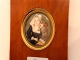 a plaque with a picture of a woman holding a child