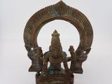 bronze statue of a seated hindu god with two attendants on a white background