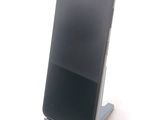a cell phone that is on a stand on a table