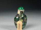 a close up of a glass bottle with a tag on it