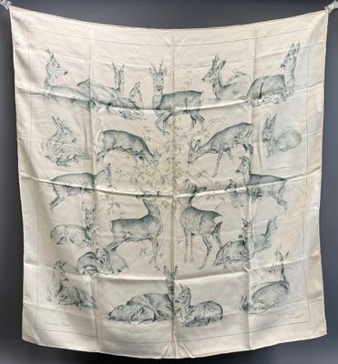 an image of a white and blue scarf with animals on it