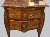 a marble top chest of drawers with a marble top