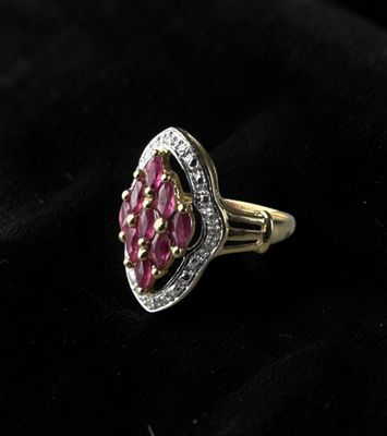 a close up of a pink stone ring on a black cloth