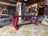 a red table with a glass top in a room