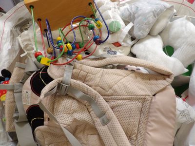 a pile of baby items and toys on the floor