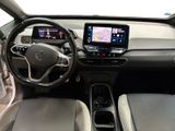 the interior of a car with a steering wheel, dashboard, and display screen