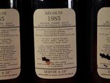three bottles of wine sitting on top of a table next to each other