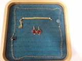a tray with a necklace, earrings, and a bracelet on it