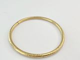 a close up of a gold ring on a white surface