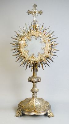 an image of a silver and gold chalicet with a cross on it