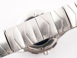 a close up of a watch on a white surface