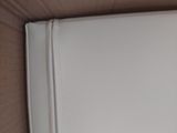 a white purse sitting on top of a wooden table