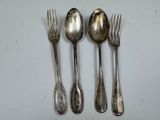 three silver spoons and a fork on a white surface