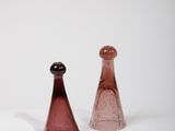 pair of pink glass salt and pepper shakers on a white surface