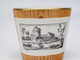 a small cup with a picture of a castle on it