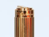 an image of a close up of a gold lighter