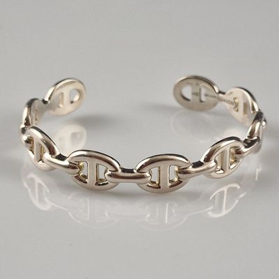 sterling silver bracelet with links and clasps on a white surface