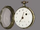 an old pocket watch with a glass in it
