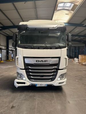 a large white truck parked in a large warehouse