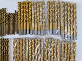 a lot of gold colored drill bits in a bag