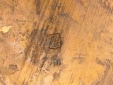 a close up of a piece of wood with a design on it