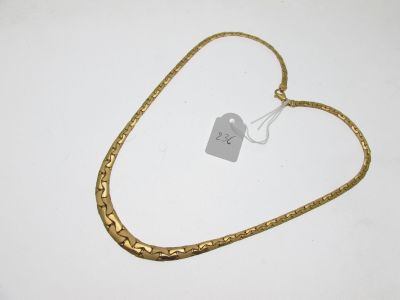 a close up of a gold chain with a tag on it