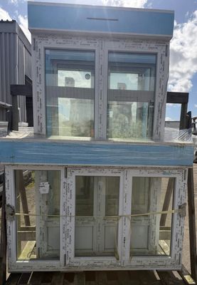 a blue and white building that has a glass door on top of it
