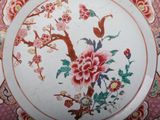 a plate with a floral design on it on a table
