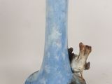 a blue vase with a bird on it on a white surface