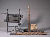 a wooden chair, a chair, and other objects on a table