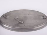 a metal plate with a hook on it on a white surface