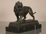 statue of a lion on a marble base on a glass table