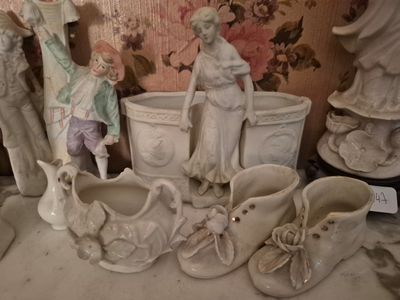 a lot of statues and vases on the table
