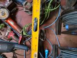 a yellow measuring tape on the floor next to a pile of tools