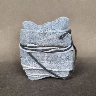 a small bag made out of old jeans on a table