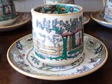 a cup and saucer sitting on a wooden table