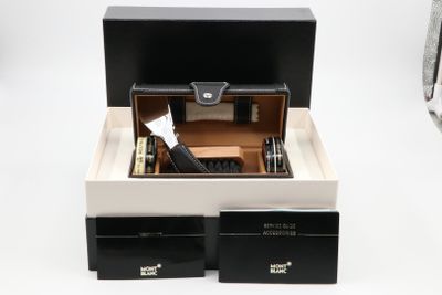 a black and white box with a watch inside of it