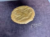a gold coin with a picture of a woman on it