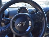 the interior of a car with a steering wheel and dashboard controls