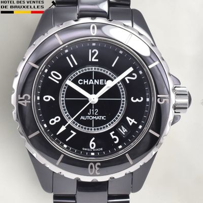a close up of a watch on a white surface