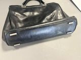black leather handbag sitting on a table in a room