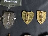 a lot of badges that are on a black table