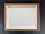 a close up of a picture of a wooden frame on a wall