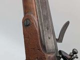 a close up of a gun on a stand with a white background