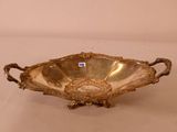 an antique silver plate with handles and handles on a white surface