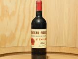 a bottle of wine sitting on top of a wooden barrel